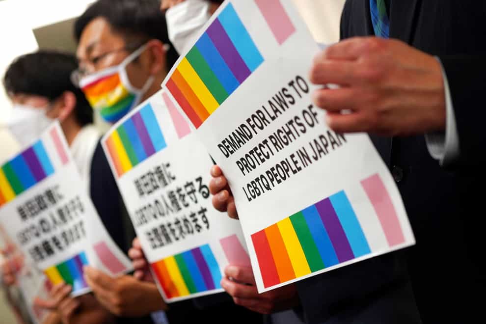 Representatives of Japanese LGBTQ people and rights groups, pose for photographers during a press conference(Eugene Hoshiko/PA)
