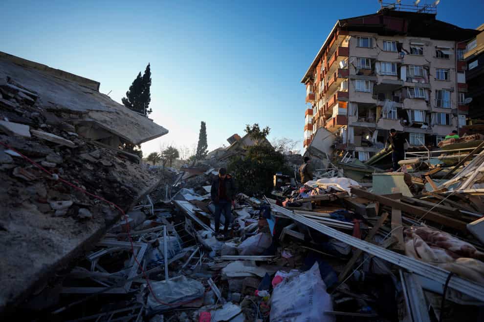 As the death toll for the 7.8 magnitude earthquakes approached 12,000 on Wednesday, a team of around 70 from the UK International Search and Rescue Team arrived in Turkey to assist with the search operation (Khalil Hamra/AP)