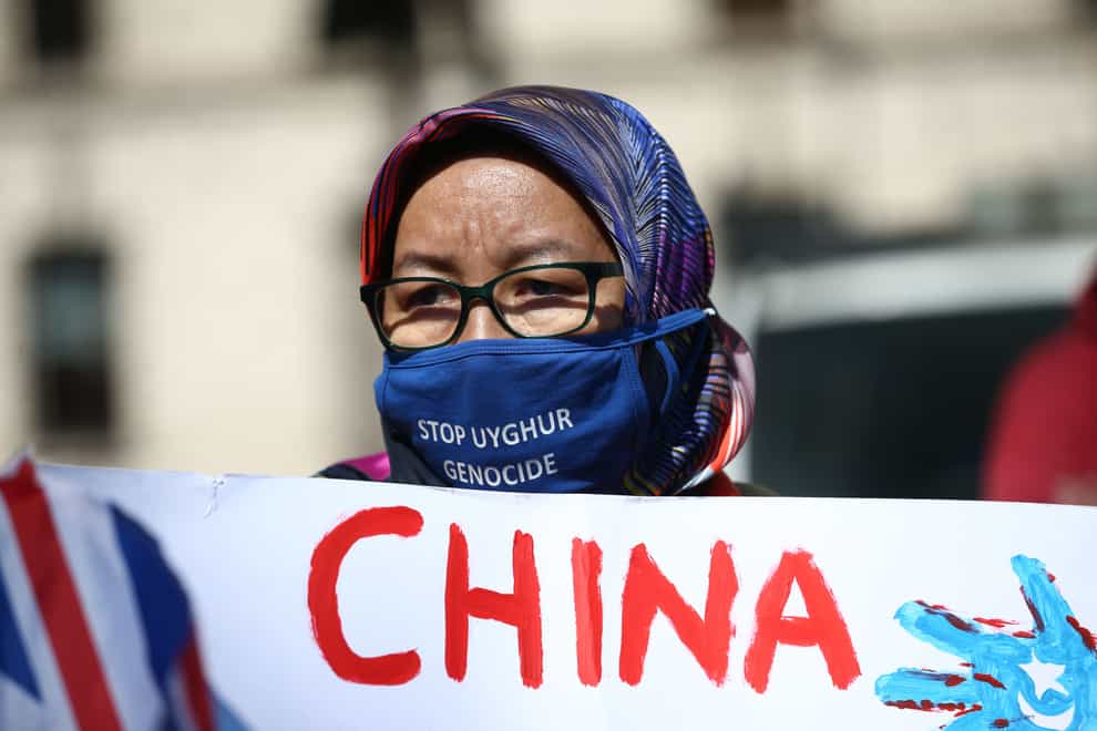 A Uighur woman during a demonstration in Parliament Square, London, in April, 2021 (Yui Mok/PA)