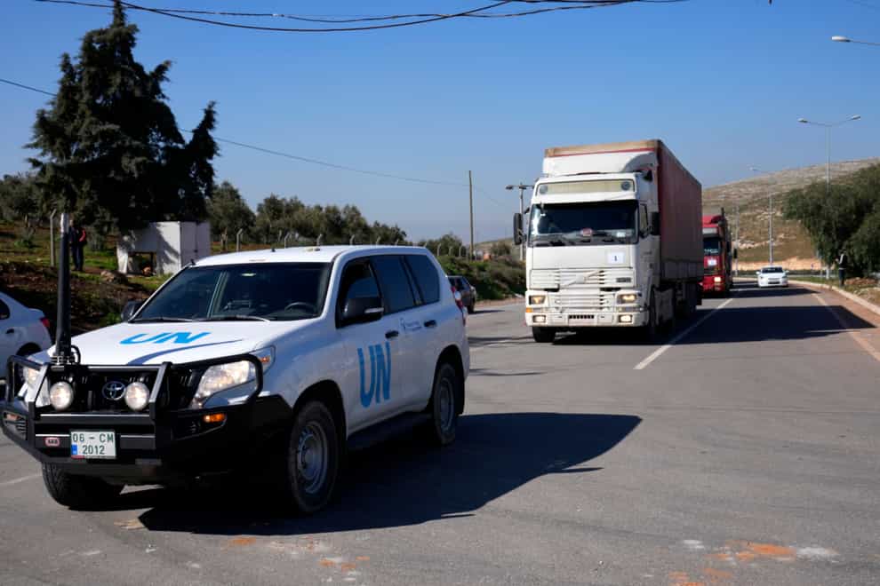 Trucks with aid for Syria follow a UN vehicle at the Turkish crossing point (Hussein Malla/AP)