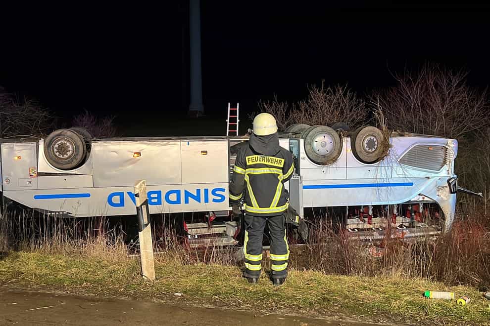 A bus belonging to a tour company from Poland is lying on its roof after an accident on the A2 near Bornstedt (dpa via AP)