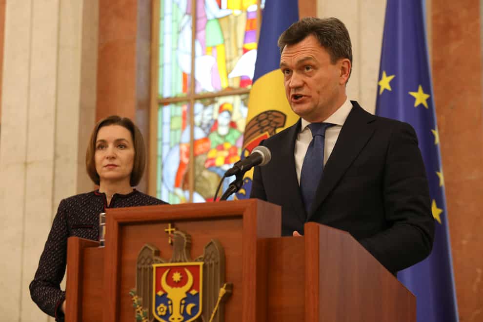 Moldovan Prime Minister designate Dorin Recean speaks after being appointed by President Maia Sandu, left, to form a new government (Aurel Obreja/AP)