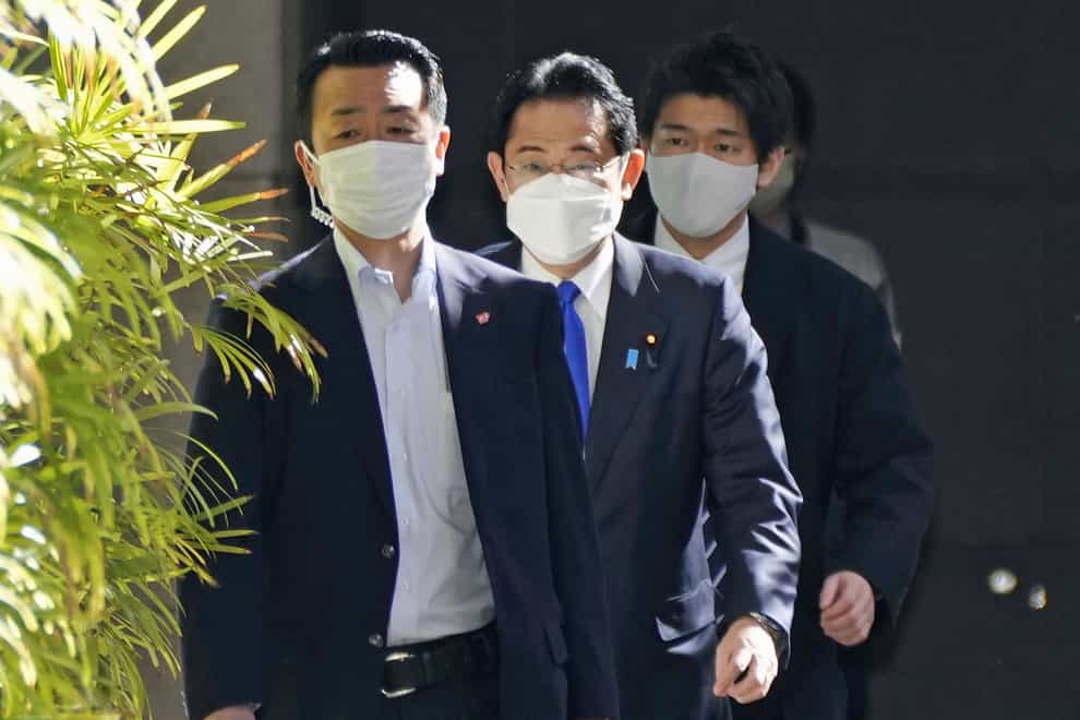 Japanese Prime Minister Fumio Kishida, centre, arrives at hospital in Tokyo (Kyodo News via AP)