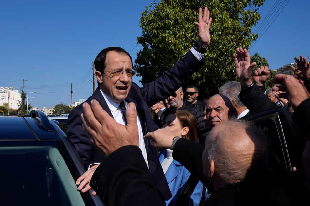 Presidential candidate Nikos Christodoulides greets his supporters after casting his vote during the presidential elections in Geroskipou, near Paphos (AP Photo/Petros Karadjias)