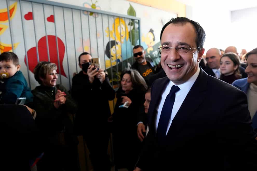 Presidential candidate Nikos Christodoulides smiles as walks with his supporters after casting his vote during the presidential elections in Geroskipou in south west coastal city of Paphos, Cyprus, Sunday, Feb. 12, 2023. Voting has started in a runoff to elect ethnically split Cyprus’ eighth new president, pitting a former foreign minister who campaigned as a unifier eschewing ideological and party divisions against a popular veteran diplomat. Some 561,000 citizens are eligible to vote and both Nikos Christoulides, the ex-foreign minister and Andreas Mavroyiannis are hoping for a higher turnout than the 72% that cast ballots in Feb. 5 first round. (AP Photo/Petros Karadjias)