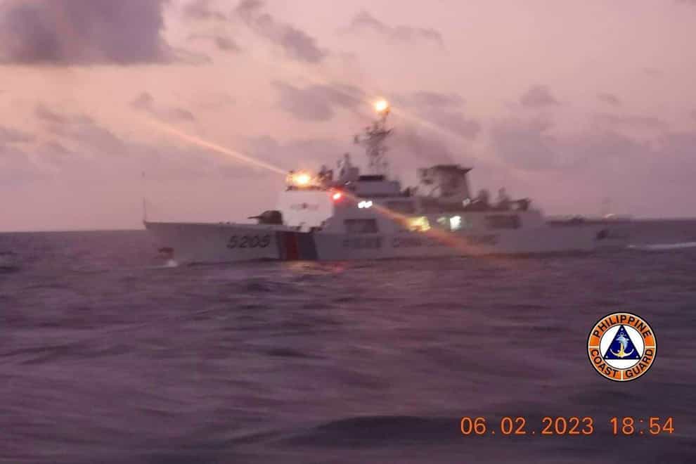 The Philippines has accused a Chinese coast guard ship of hitting a Filipino vessel with a military-grade laser and temporarily blinding some of its crew in the disputed South China Sea (Philippine Coast Guard/AP)