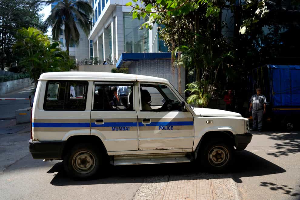 A police vehicle is seen parked at the gate of a building which houses BBC office, in Mumbai, India (Rafiq Maqbool/AP)