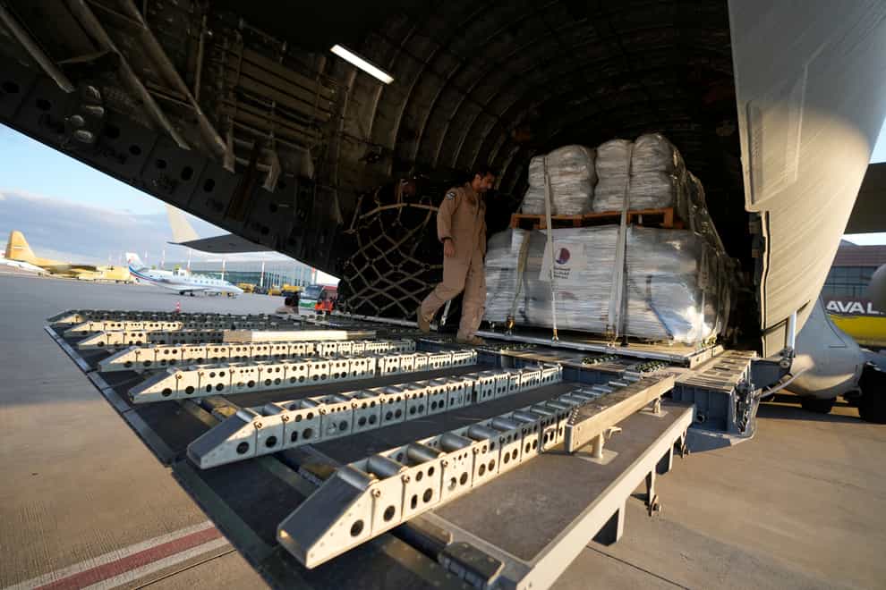 A Qatar Emiri Air Force officer prepares to offload supplies of assistance packages, in Gaziantep, southeastern Turkey (Kamran Jebreili/AP)