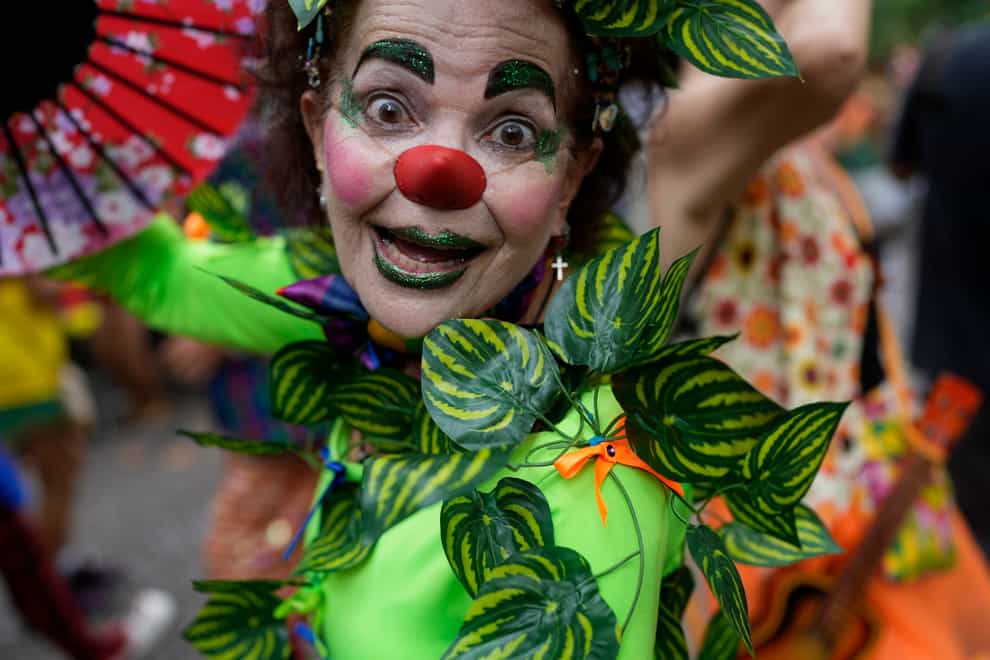 A reveller dressed as a clown participates in the ‘Gigantes da Lira’ street block party in Rio de Janeiro, Brazil, ahead of Carnival’s official February 17 opening (Silvia Izquierdo/AP/PA)