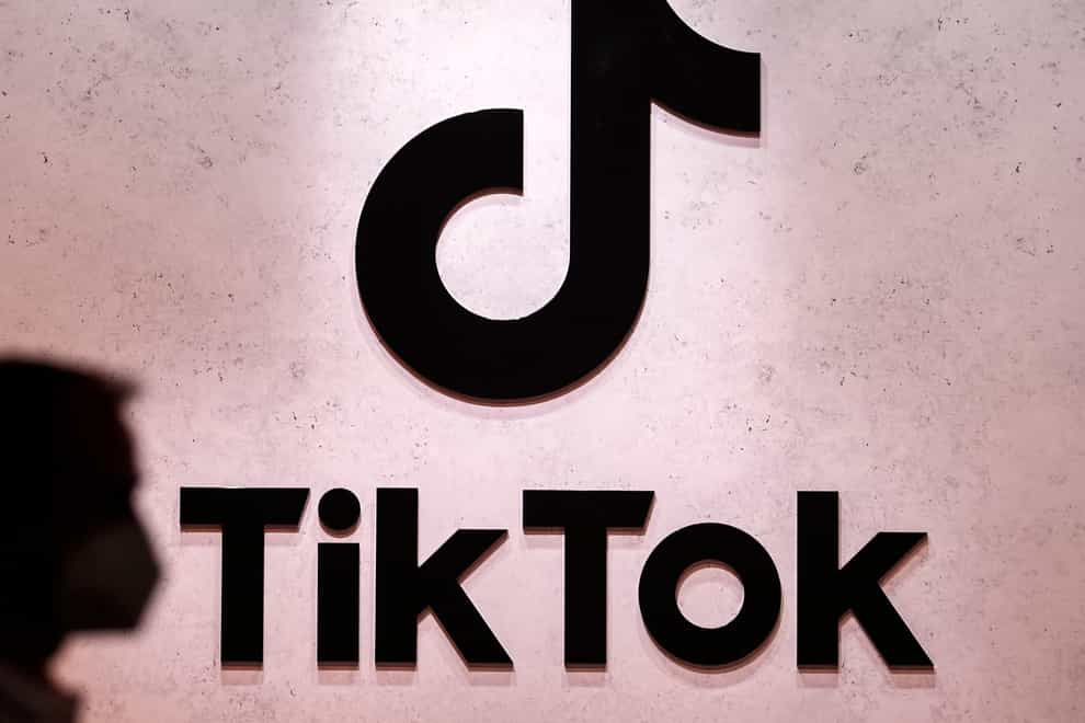 A visitor passes the TikTok exhibition stands at the Gamescom computer gaming fair in Cologne, Germany (Martin Meissner/AP/PA)