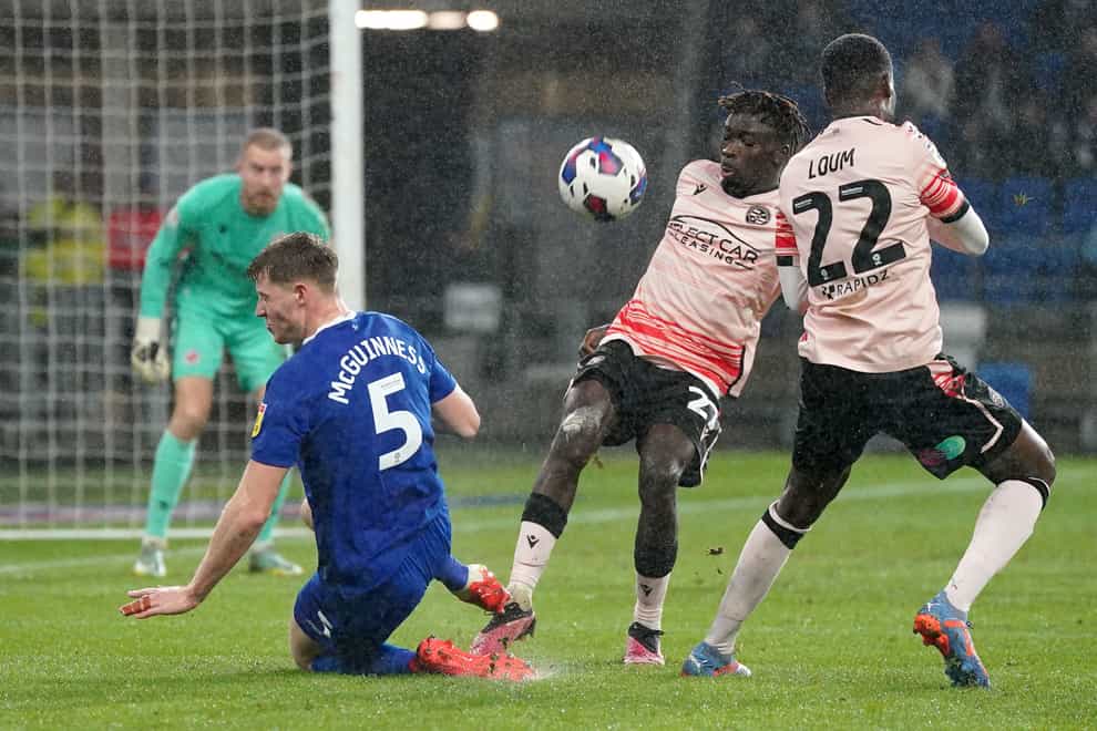 Mark McGuinness escaped with a yellow card for this foul on Amadou Mbengue (Nick Potts/PA)