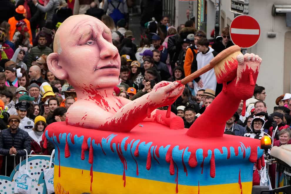 A carnival float depicts Russia’s President Vladimir Putin taking a blood bath during the traditional carnival parade in Duesseldorf, Germany (Martin Meissner/AP)
