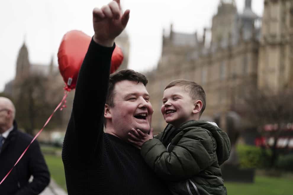 Daithi MacGabhann and his father Mairtin MacGabhann outside the Houses of Parliament in London (Jordan Pettitt/PA)