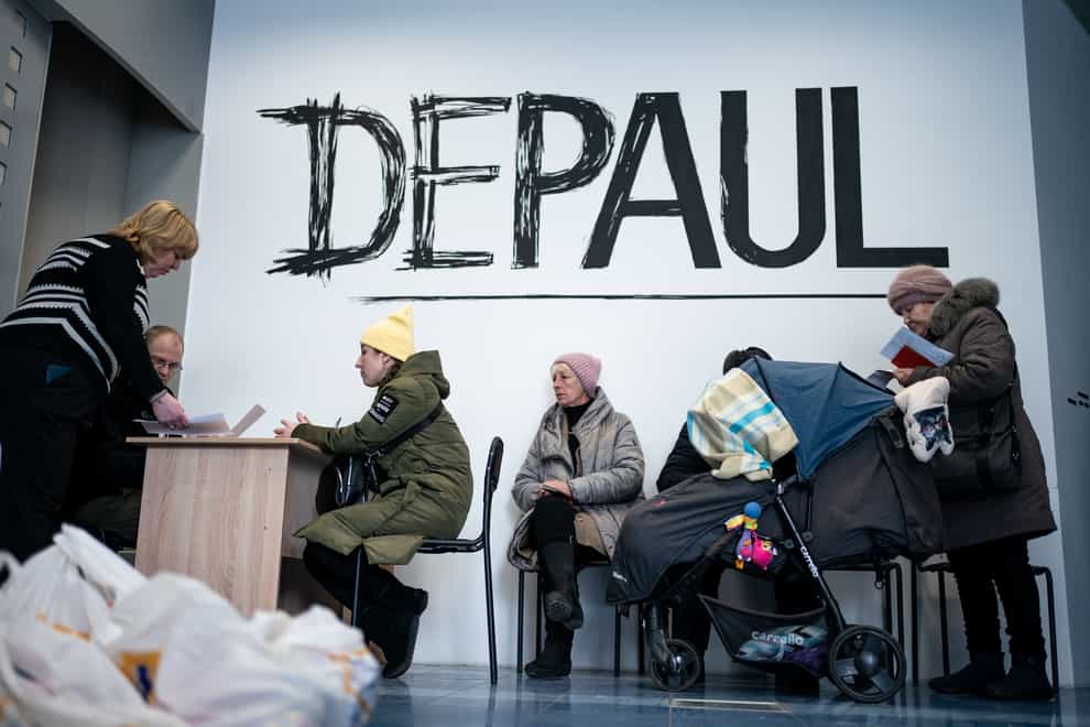 People wait to receive humanitarian aid including food and hygiene facilities for Ukrainians, at the Depaul International Day Centre in Kyiv (Aaron Chown/PA)