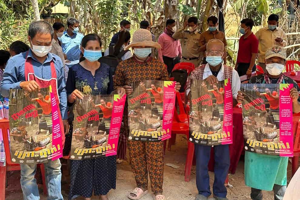 Cambodian villagers hold posters to spread awareness of H5N1 virus threats in Prey Veng eastern province (Cambodia Ministry of Health via AP)