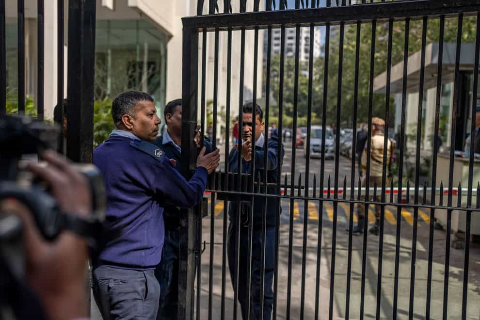 Private security guards close the gate of a building housing BBC office in New Delhi, India (AP)