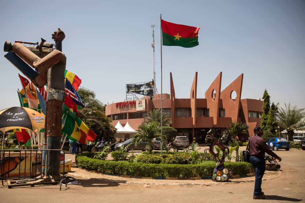 A man walks past the entrance of the headquarters of FESPACO (Pan-African Film and Television Festival) in Ouagadougou, Burkina Faso (Sophie Garcia/AP)
