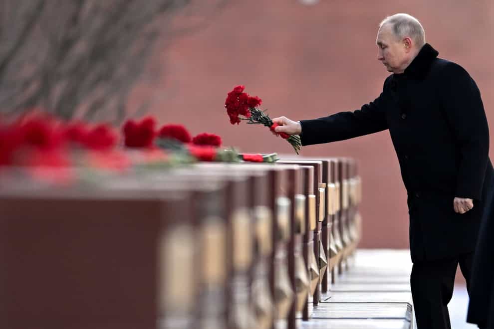 Russian President Vladimir Putin attends a wreath-laying ceremony at the Tomb of the Unknown Soldier, near the Kremlin Wall during the national celebrations of the ‘Defender of the Fatherland Day’ in Moscow, Russia (AP)