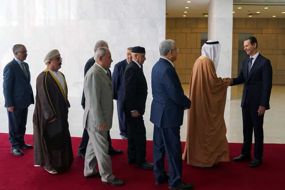 Syrian President Bashar Assad receives a delegation representing various Arab parliaments in Damascus (Sana via AP)