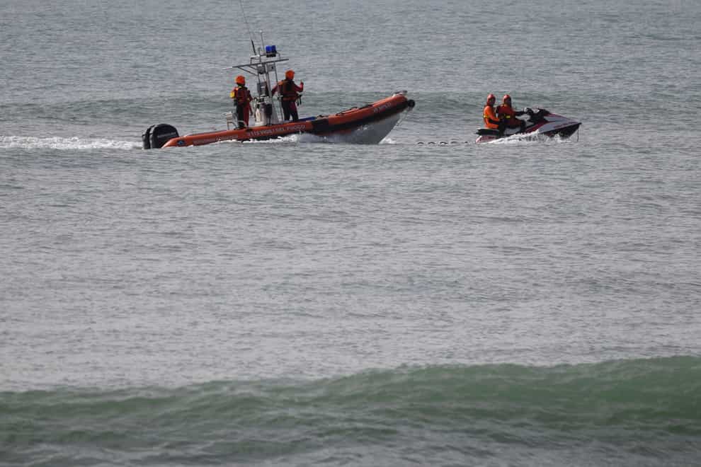 Rescue crews search for migrants feared dead after a shipwreck (Valeria Ferraro/AP)
