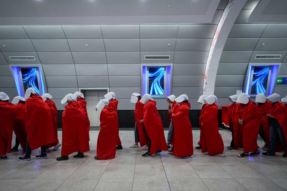 Protesters supporting women’s rights dressed as characters from The Handmaid’s Tale TV series travel to a protest against plans by Prime Minister Benjamin Netanyahu’s new government to overhaul the judicial system, at a railway station in Jerusalem (Ohad Zwigenberg/AP/PA)