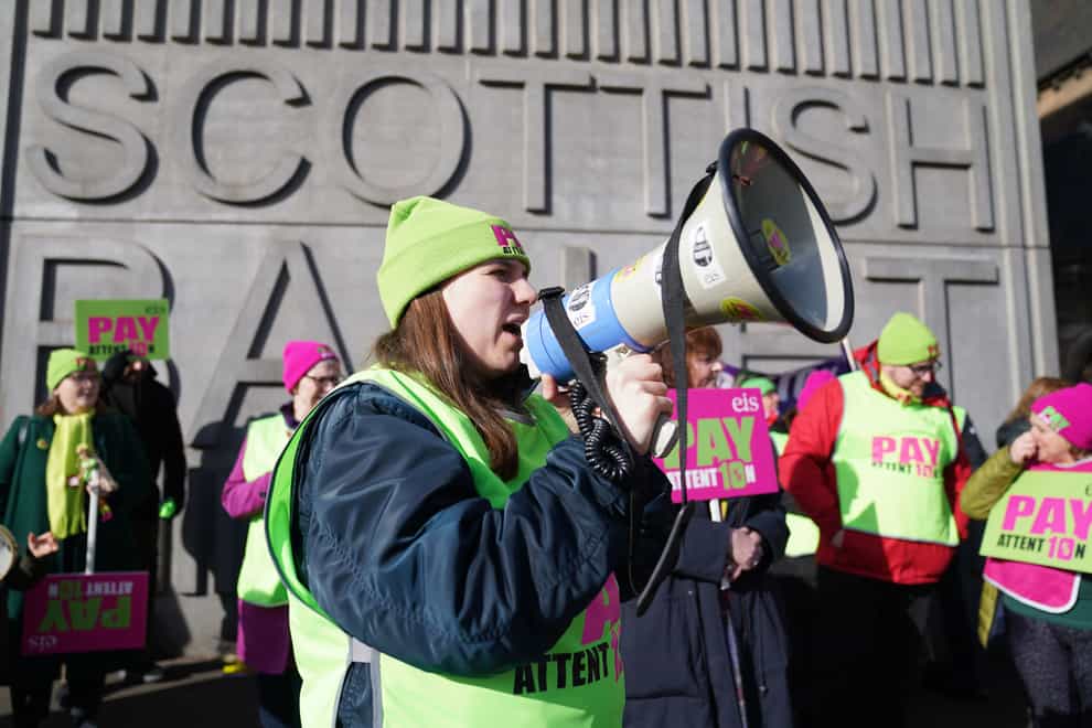 Teachers from the Educational Institute of Scotland (EIS) union take part in a rally outside the Tramway in Glasgow on day two of the strike action in a dispute over pay