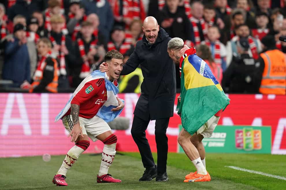 Manchester United manager Erik ten Hag, centre, celebrates with Lisandro Martinez, left, and Antony after winning the Carabao Cup (John Walton/PA)