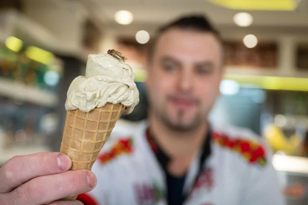 Thomas Micolino holds a cricket-flavoured ice cream in Rottenburg am Neckar, Germany (Marijan Murat/dpa via AP)
