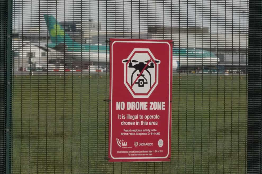 A warning sign against the use of drones on the perimeter fencing at Dublin Airport in the Republic of Ireland (Niall Carson/PA)