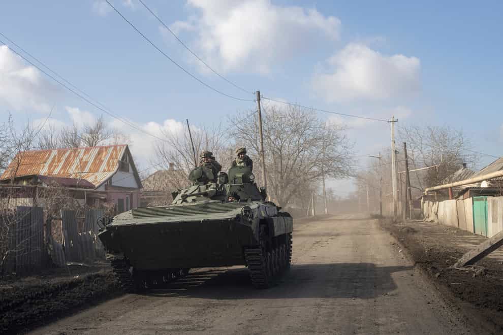 A Ukrainian APC drives towards frontline positions near Bakhmut (AP)
