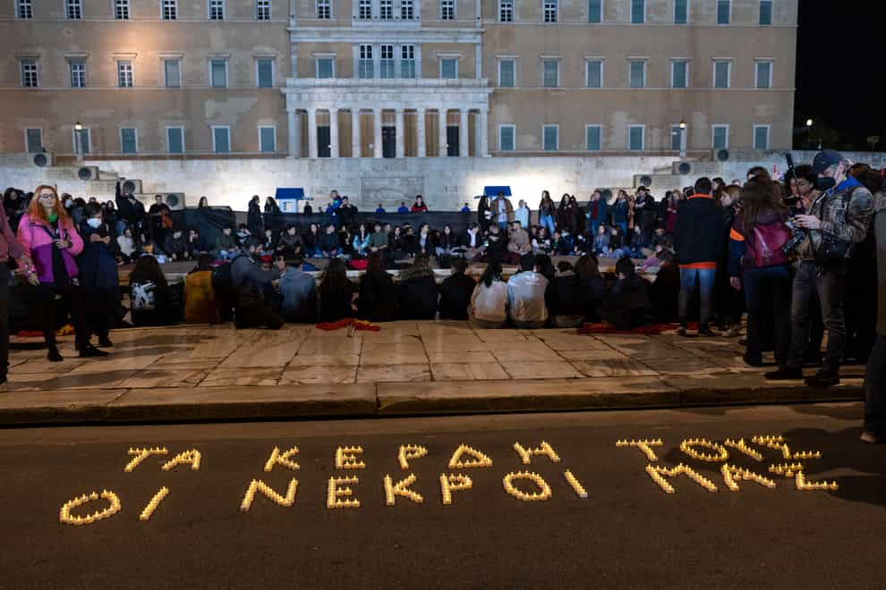 Demonstrators in front of the parliament in Athens. The slogan reads Their profit, Our dead (Yorgos Karahalis/AP)