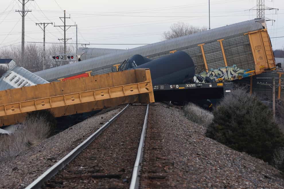 Multiple cars of a Norfolk Southern train lie on the ground after derailing in Ohio (Bill Lackey/Springfield-News Sun via AP)
