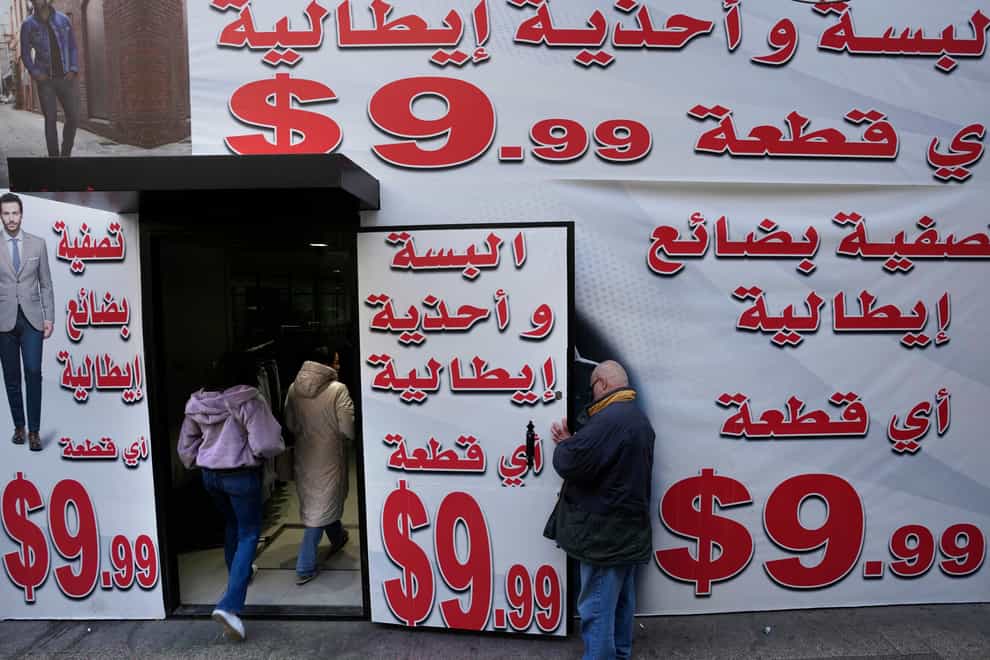 Store displays advertising in Arabic that reads “Italian clothes and shoes for 9.99 $” in Beirut, Lebanon (Hassan Ammar/AP)
