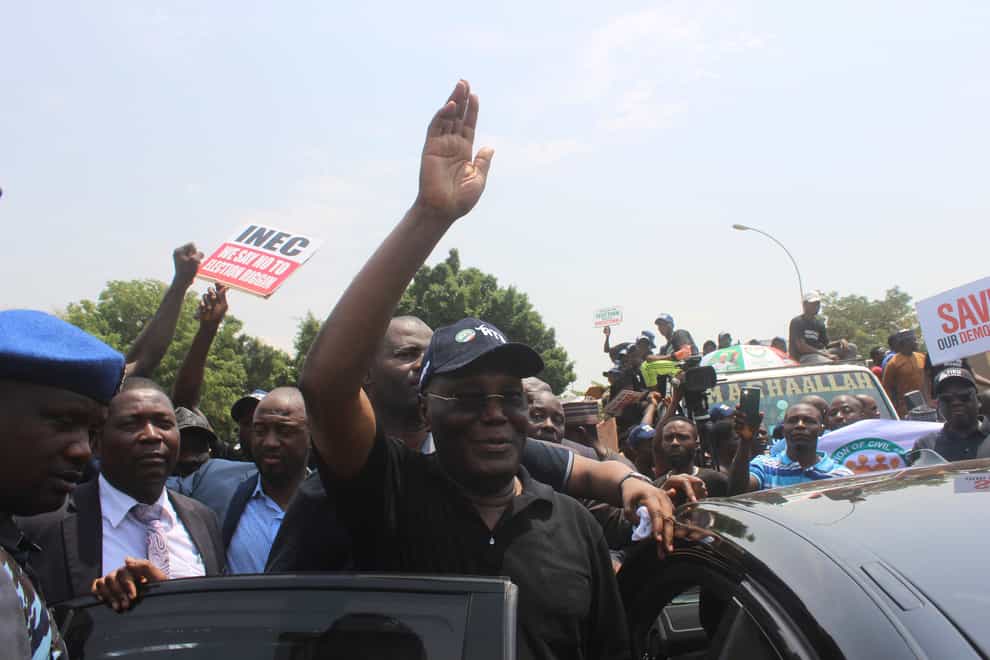 Atiku Abubakar of the Peoples Democratic Party and second place candidate greets his supporters during a protest (Gbemiga Olamikan/AP)