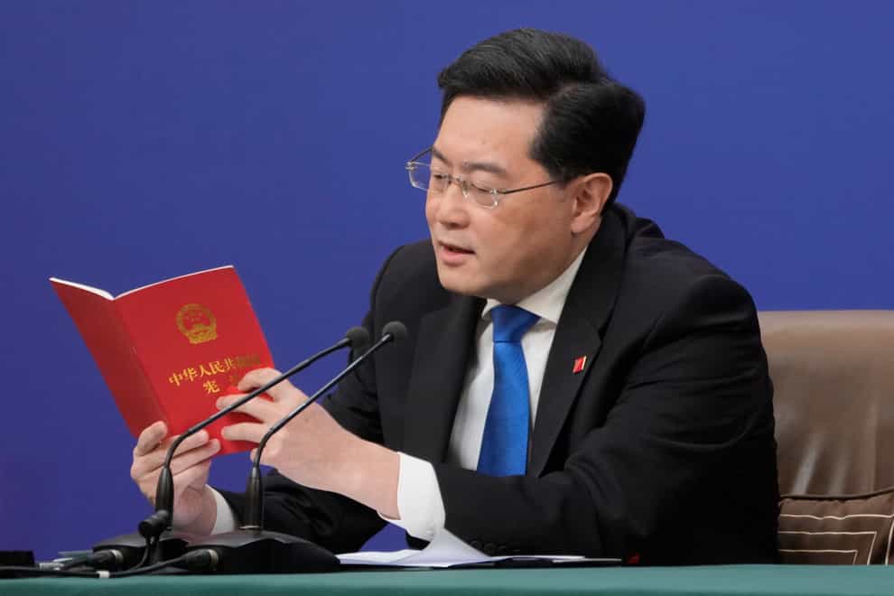 Chinese foreign minister Qin Gang reads from the Chinese constitution when answering a question about Taiwan (Mark Schiefelbein/AP)