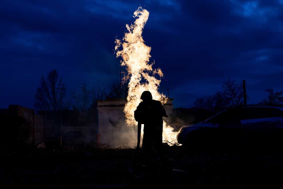 A rescue worker puts out a fire at a destroyed gas distribution point after a Russian attack in Kostiantynivka, Ukraine (Evgeniy Maloletka/AP)