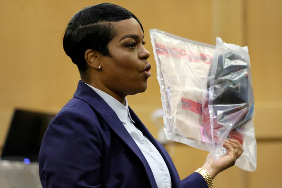 During her closing arguments in the XXXTentacion murder trial, assistant state attorney Pascale Achille holds up a camouflage hat with a red brim that was seen worn by shooting suspect Michael Boatwright (Amy Beth Bennett/South Florida Sun-Sentinel/AP)