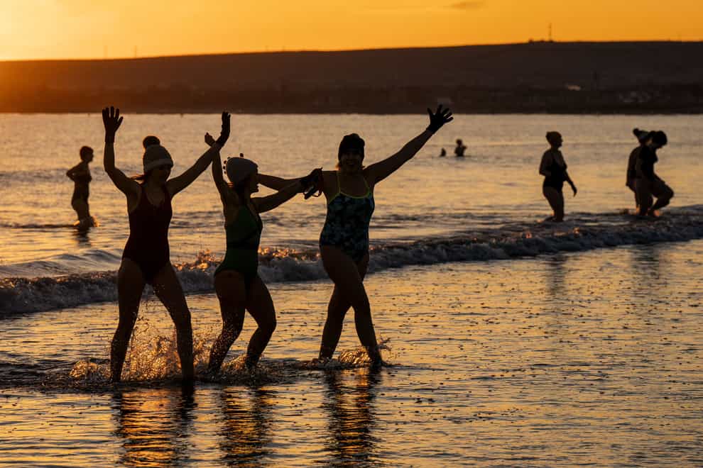 Hundreds of swimmers take a sunrise dip in the Firth of Forth at Portobello (Jane Barlow/PA)