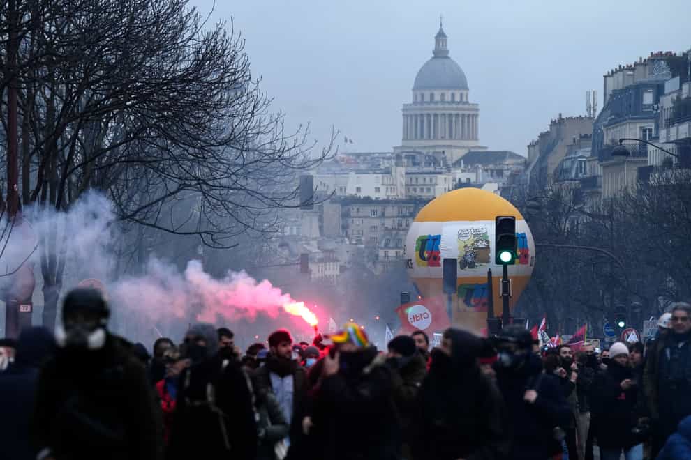 Protesters march, with the Pantheon monument in background, during a demonstration in Paris on Tuesday (Lewis Joly/AP)
