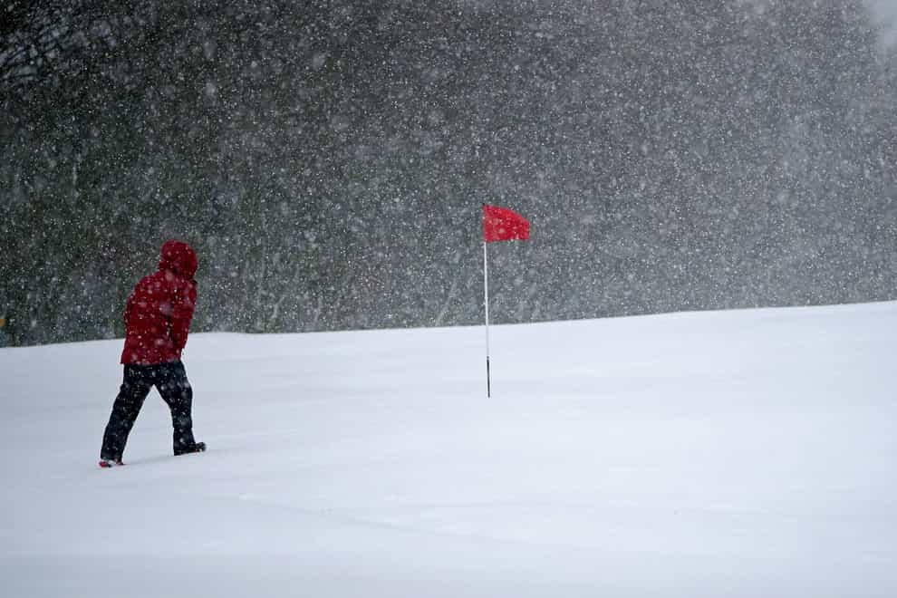 Snow falls at the Saddleworth Moor golf course near Oldham (Peter Byrne/PA)