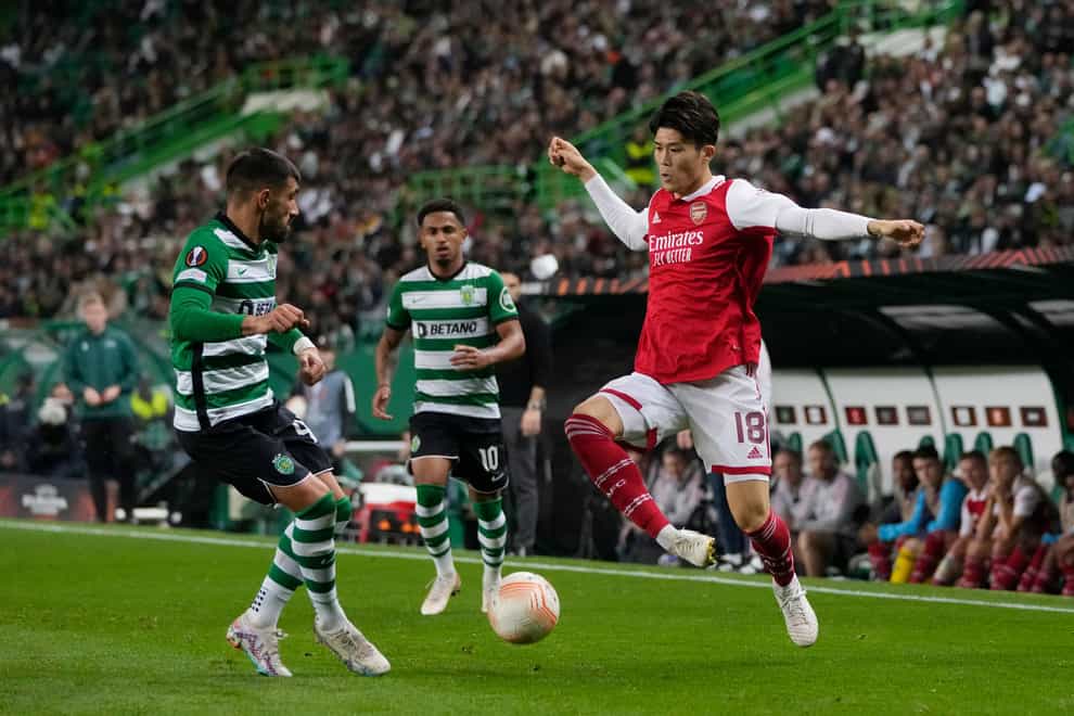 Arsenal’s Takehiro Tomiyasu, right, challenges for the ball (Armando Franca/AP)
