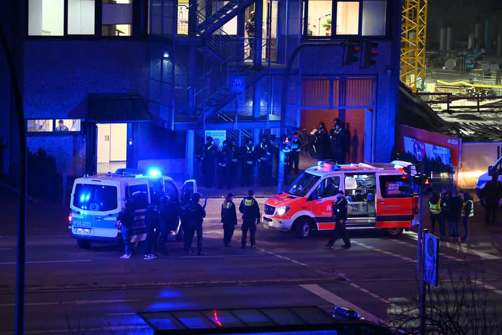 Armed police officers near the scene of a shooting in Hamburg (Jonas Walzberg/dpa via AP)