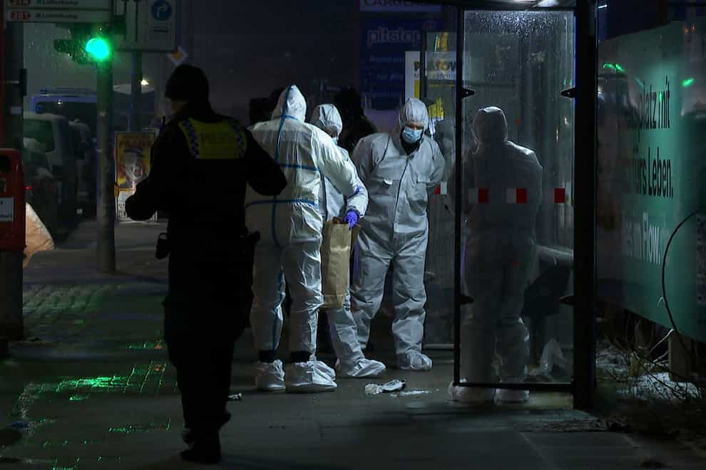 Investigators and forensic experts stand outside a Jehovah’s Witness building in Hamburg, Germany (Steven Hutchings/Tnn/dpa/AP)