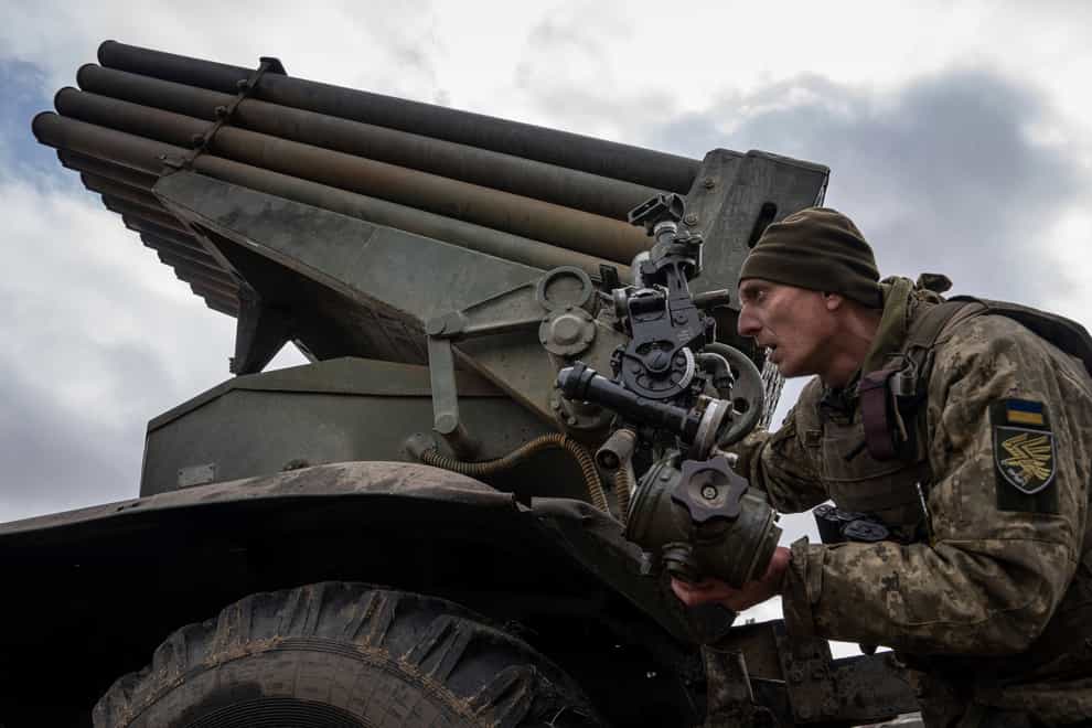 A Ukrainian paratrooper aims to fire an MSLR BM-21 “Grad” towards Russian positions at the frontline near Kreminna, Ukraine (Evgeniy Maloletka/AP)