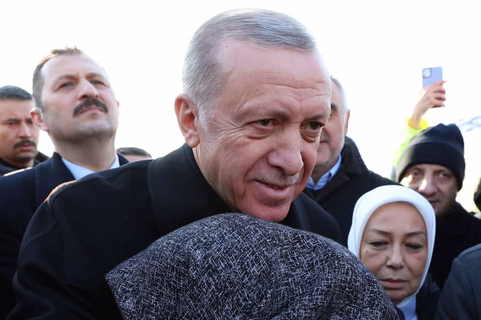 Turkey’s President Recep Tayyip Erdogan and a survivor hug each other after February’s huge earthquake (Turkish Presidency/AP )