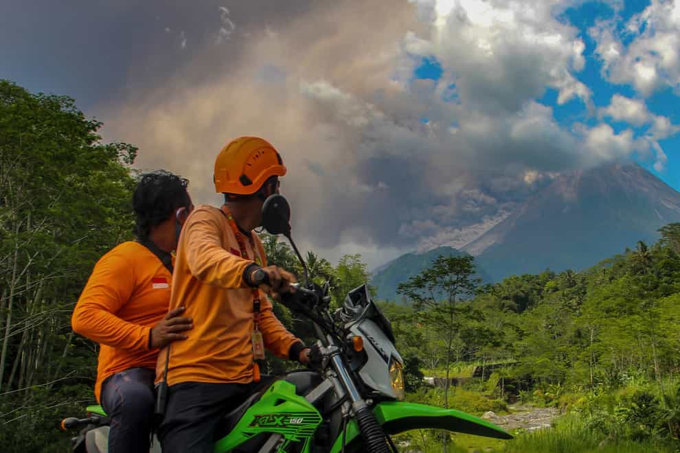 Men watch as Mount Merapi erupts (Slamet Riyadi/AP)