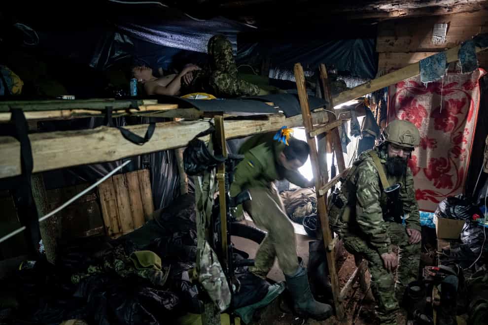Ukrainian paratroopers rest inside a dugout at the frontline near Bakhmut, Ukraine (Evgeniy Maloletka/AP)