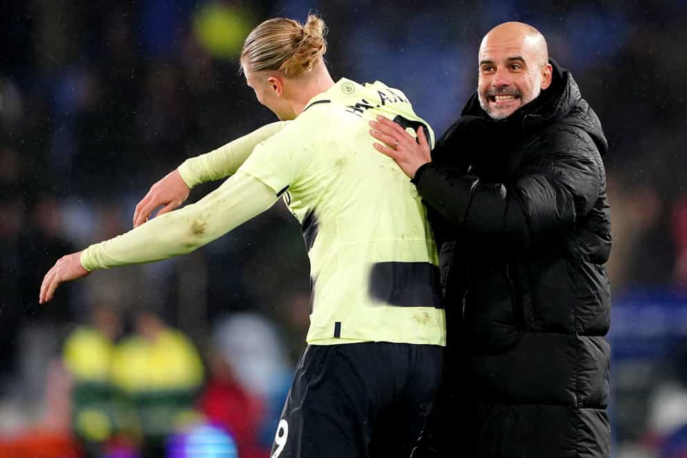 Erling Haaland, left, and Pep Guardiola celebrate victory over Crystal Palace (Zac Goodwin/PA)