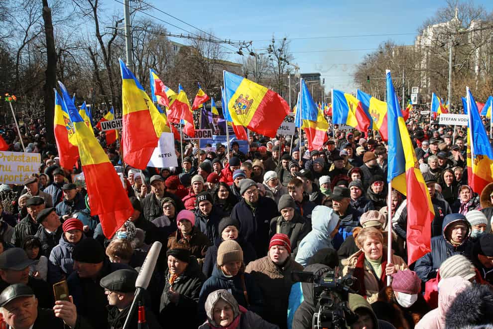 People wave flags during a protest initiated by the Movement for the People and members of Moldova’s Russia-friendly Shor Party, against the pro-Western government and low living standards, in Chisinau, Moldova (Aurel Obreja/AP)
