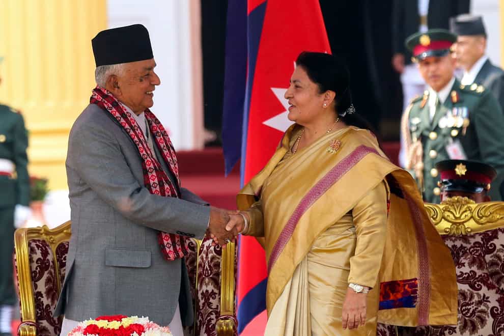 Outgoing President Bidhya Devi Bhandari, right, congratulates Nepal’s newly elected president Ram Chandra Poudel (AP)